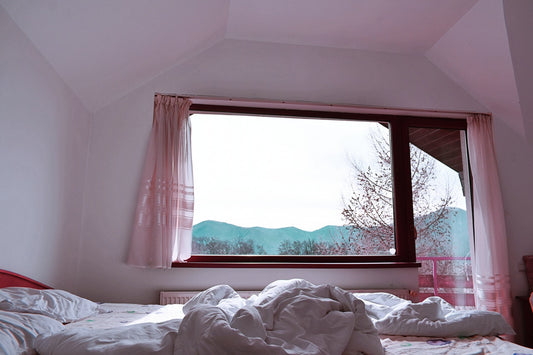 Bedroom with pink net curtains